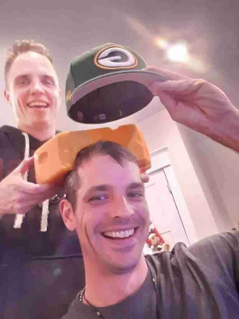 packers cheesehead on adult mans head